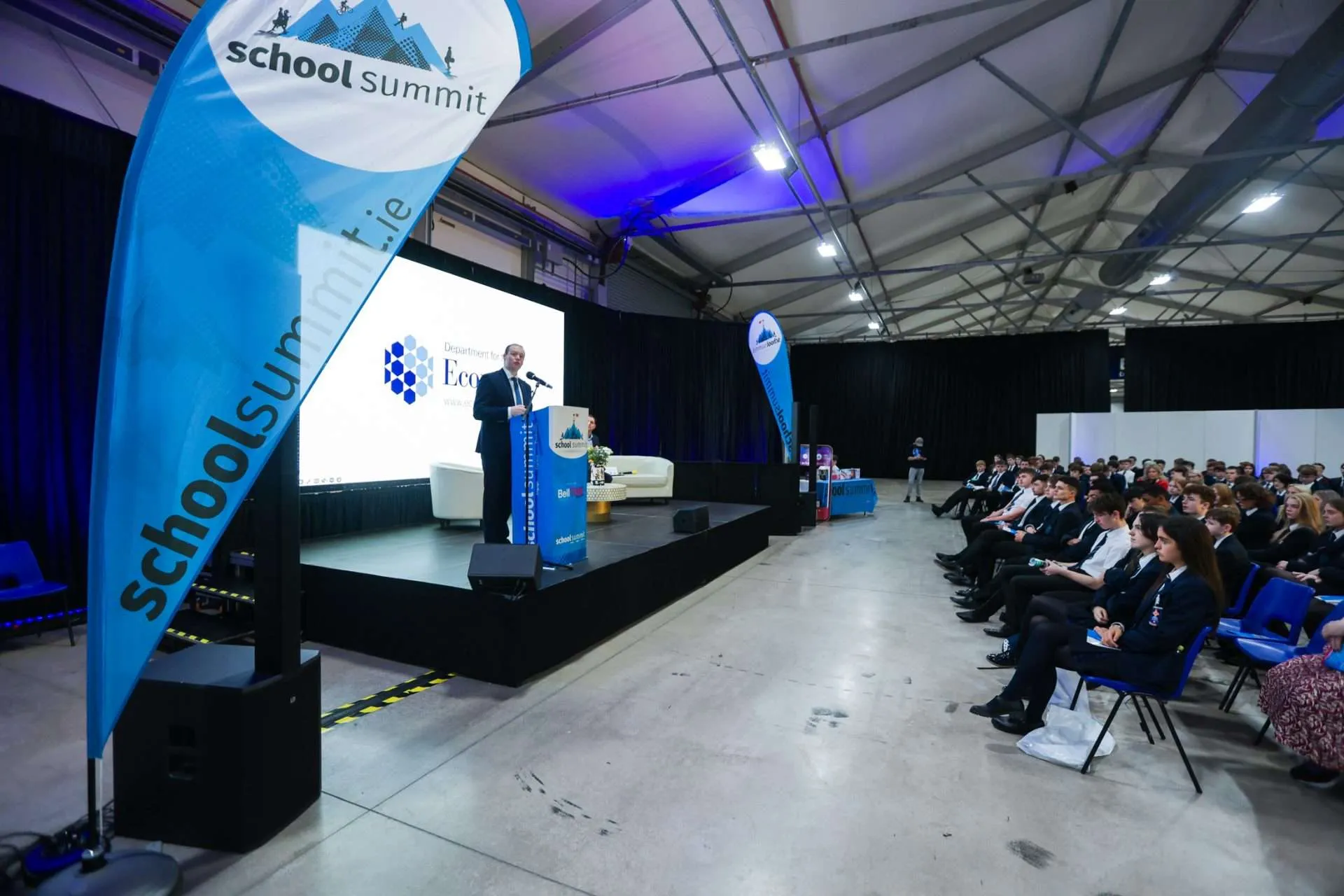 Keynote presentation at School Summit career expo with LED video wall and full audience